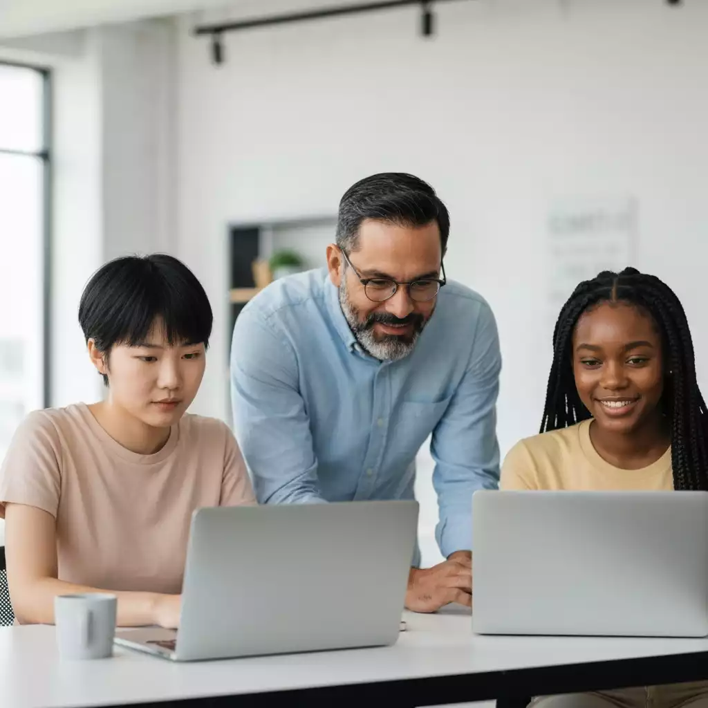 Diverse group of people using laptops and tablets for online rate comparison
